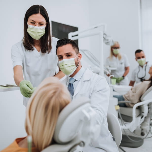 Dental professionals working with a patient